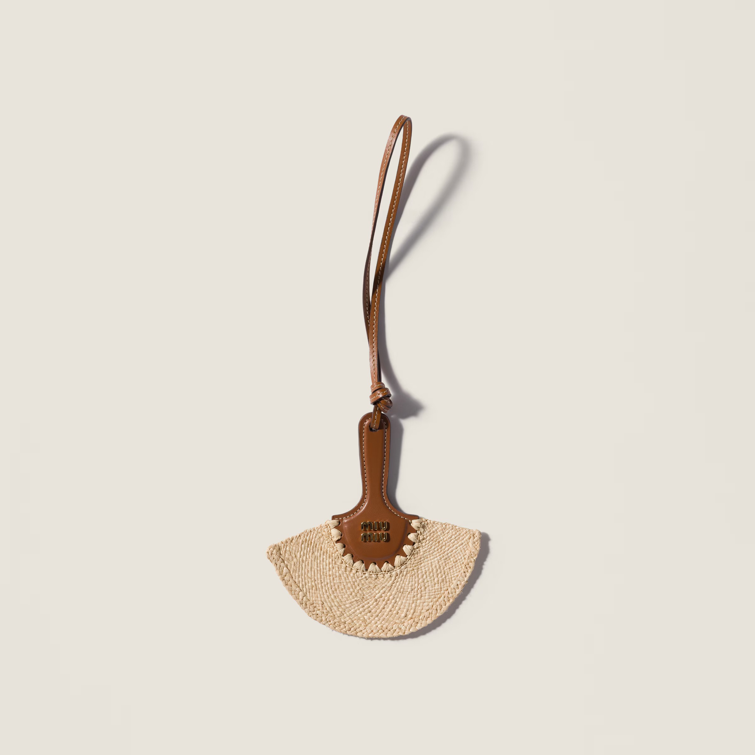 Raffia and leather trick, 390€, Miu Miu.
